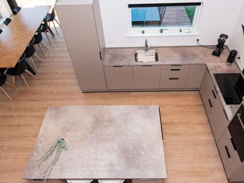 a kitchen with a sink and a table at 12 person holiday home in Ansager-By Traum in Ansager