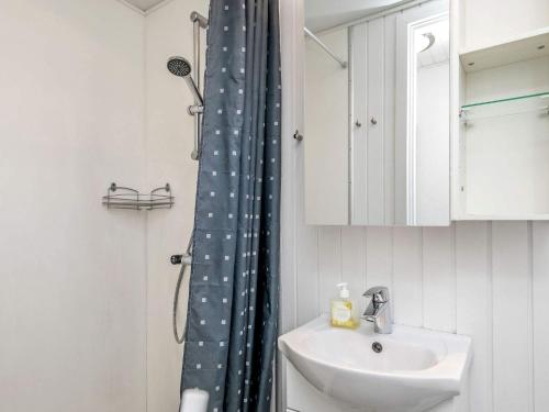 a bathroom with a sink and a shower curtain with stars at Apartment Vestervig III in Vestervig