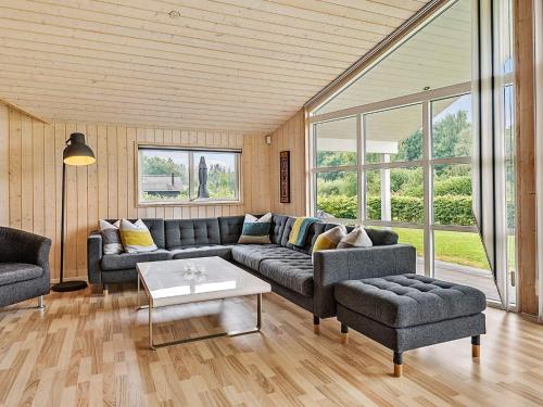 a living room with a couch and a table at 8 person holiday home in Ansager in Ansager
