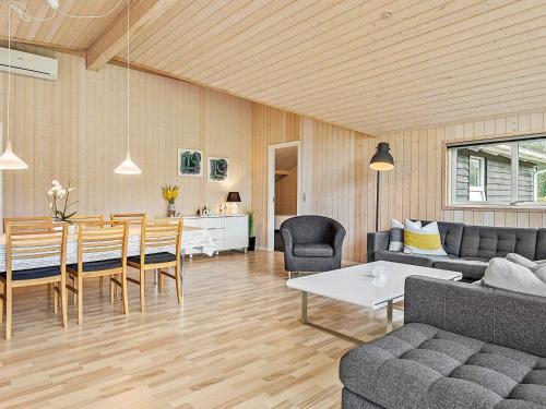 a living room with a table and a dining room at 8 person holiday home in Ansager in Ansager