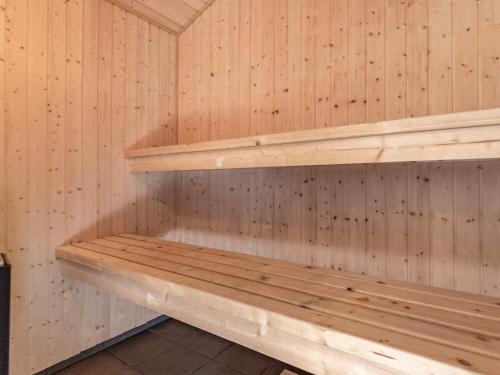 a sauna with wooden shelves on a wall at 8 person holiday home in Fjerritslev in Fjerritslev