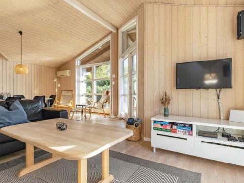 a living room with a couch and a table at 8 person holiday home in Fjerritslev in Fjerritslev