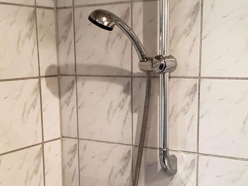 y baño con ducha con cabezal de ducha. en Holiday home Væggerløse CCXIII en Bøtø By