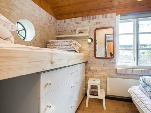 a tiny house with a bedroom and a bathroom at Holiday Home Elvervej in Ågerup