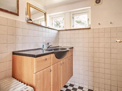 a bathroom with a sink and a mirror at Holiday home Aakirkeby XXXIV in Vester Sømarken