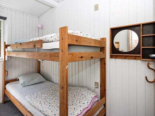two bunk beds in a room with a mirror at Holiday home Hejls LVI in Hejls