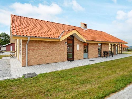 a brick house with an orange roof at 8 person holiday home in Egernsund in Egernsund