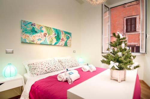a bedroom with a christmas tree on a bed at Bye Bye Roma Pantheon Suite in Rome