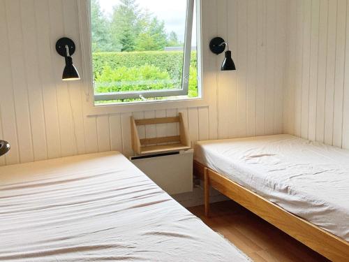 Bøtø ByにあるThree-Bedroom Holiday home in Væggerløse 39のツインベッド2台 窓付きの部屋