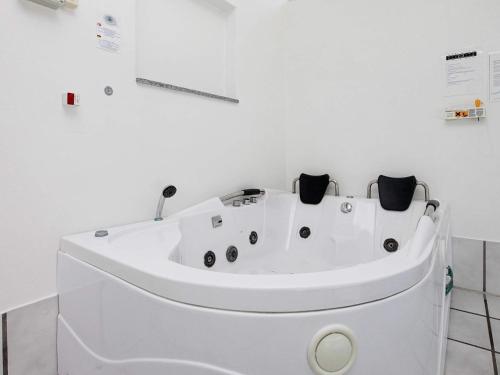 a white bath tub in a white room with at 12 person holiday home in V ggerl se in Marielyst