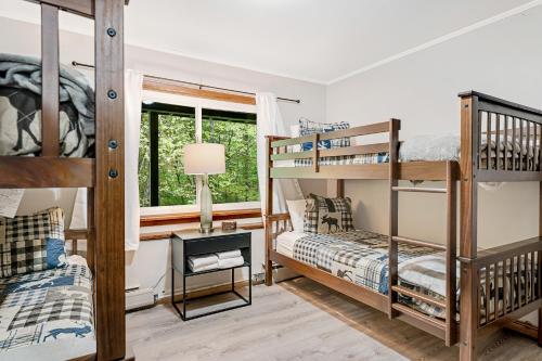 a bedroom with bunk beds and a window at Rocky Red in Bromley Village