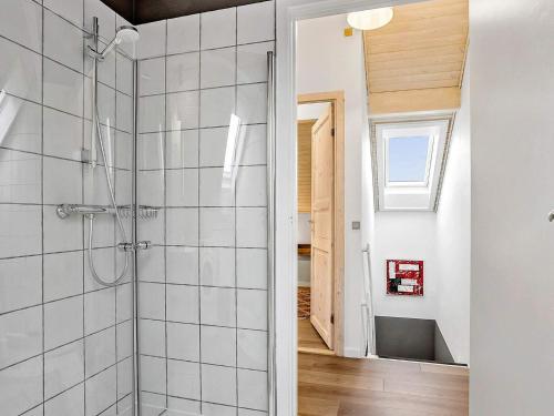 a bathroom with a shower with white tiles at 5 person holiday home in Rømø-By Traum in Sønderby