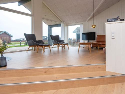 a living room with chairs and a table and a television at 8 person holiday home in Sydals in Mommark