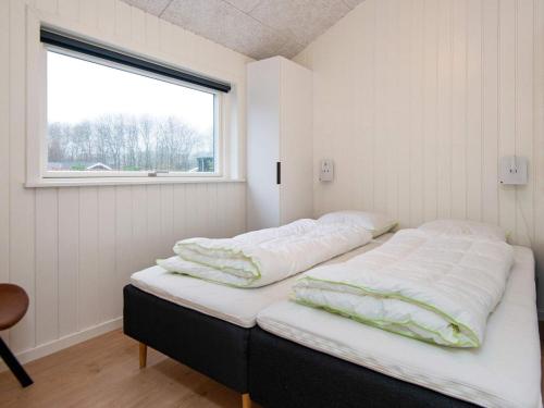 a bedroom with two beds in a room with a window at 8 person holiday home in Sydals in Mommark