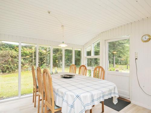 a dining room with a table and chairs at 5 person holiday home in H jslev in Højslev