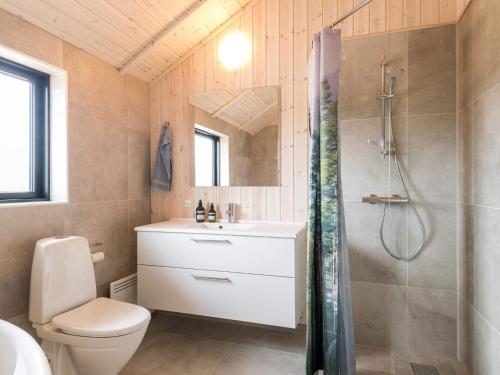 a bathroom with a shower and a toilet and a sink at 8 person holiday home in Fanø in Fanø