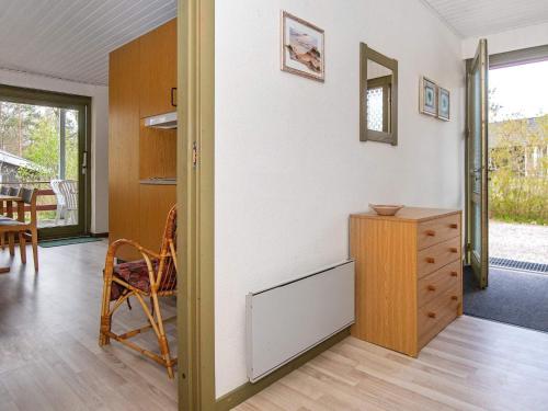 a room with a table and a chair and a cabinet at 6 person holiday home in Glesborg in Glesborg