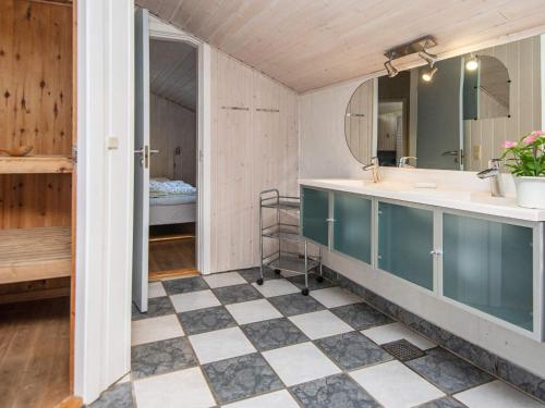 a bathroom with a sink and a mirror at Four-Bedroom Holiday home in Glesborg 2 in Glesborg