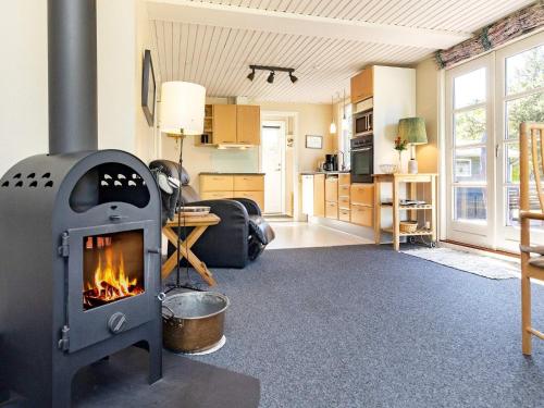 a living room with a wood stove in it at 6 person holiday home in Nibe in Nibe