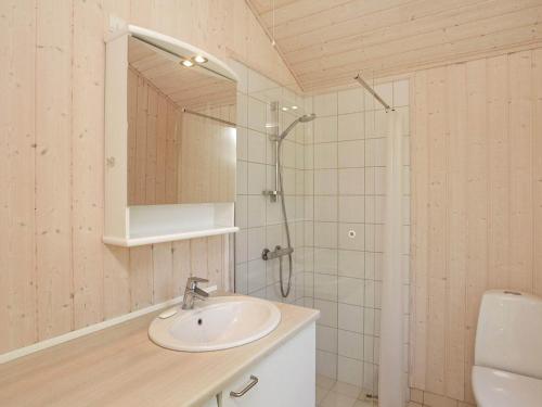 a white bathroom with a sink and a shower at 5 person holiday home in V ggerl se in Marielyst