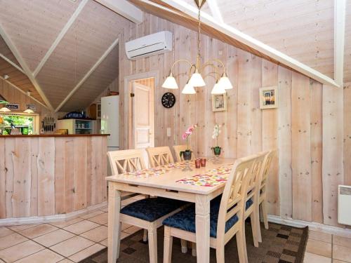 a dining room with a wooden table and chairs at 6 person holiday home in Ansager-By Traum in Ansager