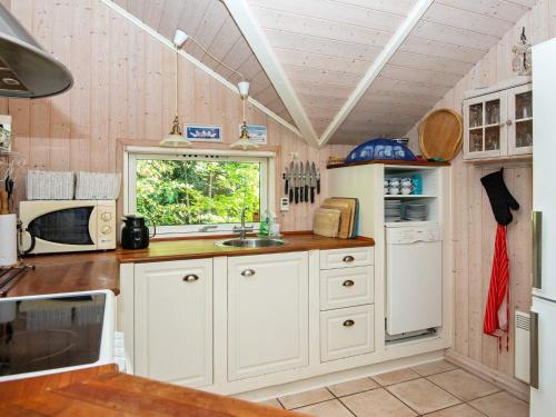 a kitchen with white cabinets and a sink at 6 person holiday home in Ansager-By Traum in Ansager
