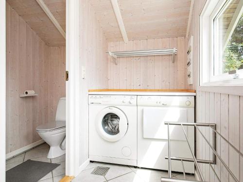 オテルプにあるThree-Bedroom Holiday home in Otterup 1のバスルーム(洗濯機、乾燥機、トイレ付)