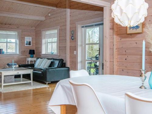 a living room with a table and a couch at 4 person holiday home in Egå in Egå