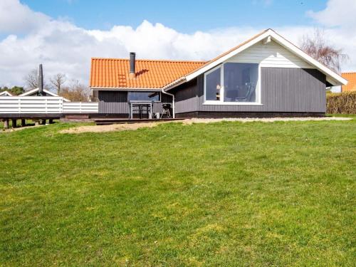 a house with a large grassy field in front of it at 7 person holiday home in Sydals in Sarup