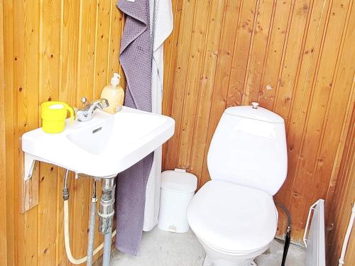 a bathroom with a white sink and a toilet at Holiday home Allingåbro XXIII in Allingåbro