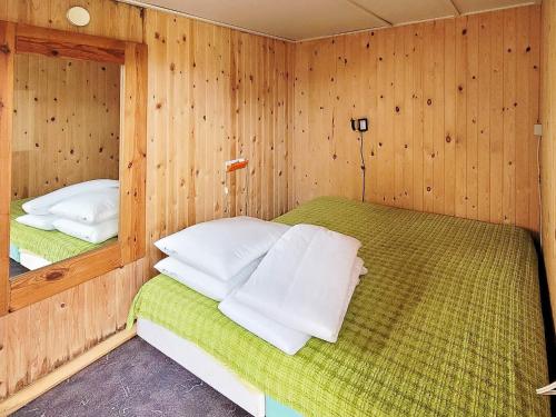 a bedroom with two beds in a wooden room at Holiday home Allingåbro XXIII in Allingåbro