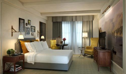 a hotel room with a bed and a television at InterContinental New York Barclay Hotel by IHG in New York