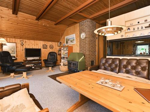 a living room with a table and leather furniture at 6 person holiday home in N rre Nebel in Nørre Nebel