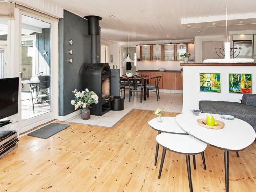 a living room with a table and a living room at 8 person holiday home in Glesborg in Glesborg