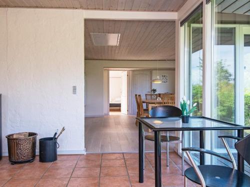 a dining room with a glass table and chairs at 4 person holiday home in B rkop in Børkop