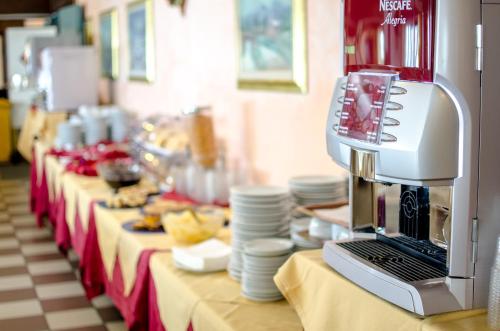 a table with a coffee maker on top of it at Hotel Residence Club Primula in Pescasseroli