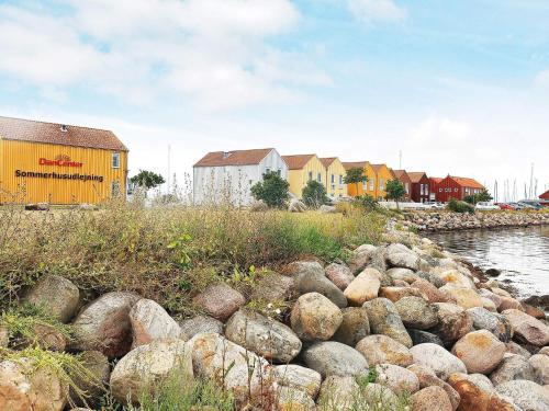 a bunch of rocks on the side of a river at 4 person holiday home in Rudk bing in Rudkøbing