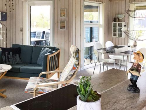 a living room with a couch and a table at 4 person holiday home in Hemmet in Hemmet