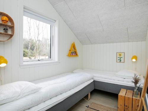 a room with two beds and a window at Holiday home Læsø VII in Læsø