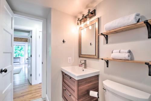 a bathroom with a sink and a mirror at Tranquil Port Republic Home with Water Views! in Prince Frederick