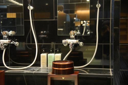 a bathroom counter with two sinks and two faucets at Hotel Sugicho in Kyoto