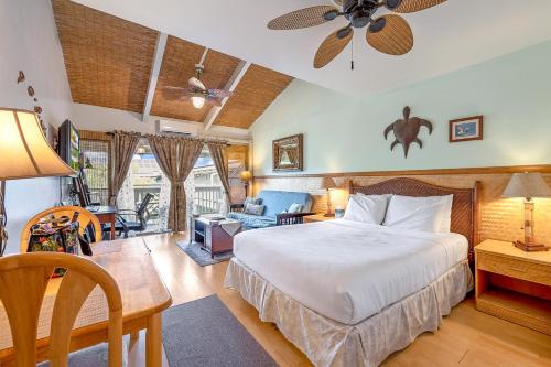 a bedroom with a bed and a living room at Kihei Bay Surf 236 in Kihei