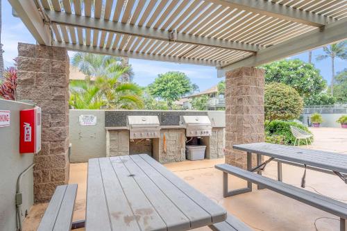 a picnic table and a grill on a patio at Kihei Bay Surf 236 in Kihei
