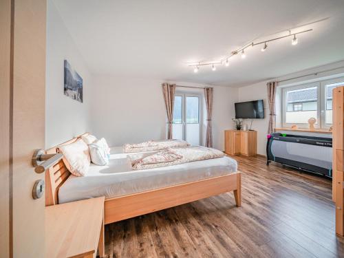 1 dormitorio con 1 cama y TV en Apartment Daisy, en Stuhlfelden