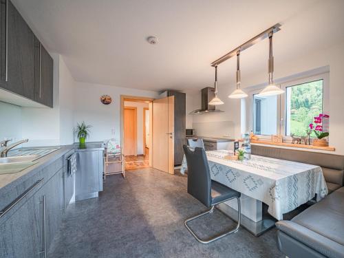 a kitchen and dining room with a table and chairs at Apartment Daisy in Stuhlfelden
