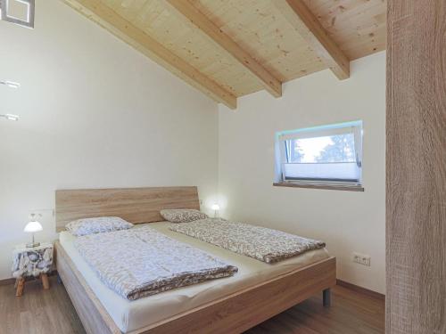 a bedroom with a bed and a window at Michelle Top 1 in Bramberg am Wildkogel
