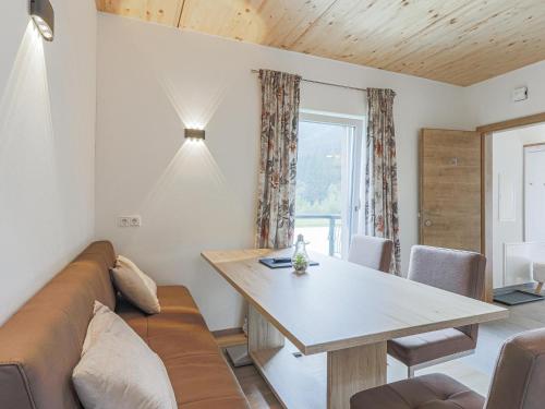 a living room with a couch and a table at Tobias Top 2 in Bramberg am Wildkogel