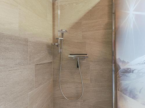 a shower with a hose in a bathroom at Tobias Top 2 in Bramberg am Wildkogel