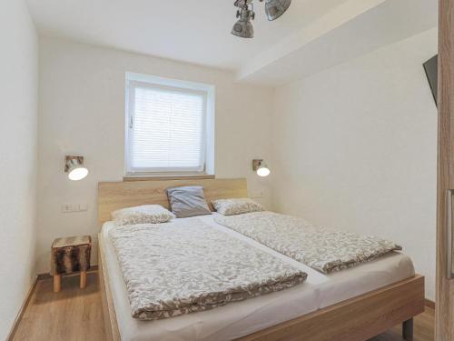 a bedroom with a large bed and a window at Celine Top 3 in Bramberg am Wildkogel
