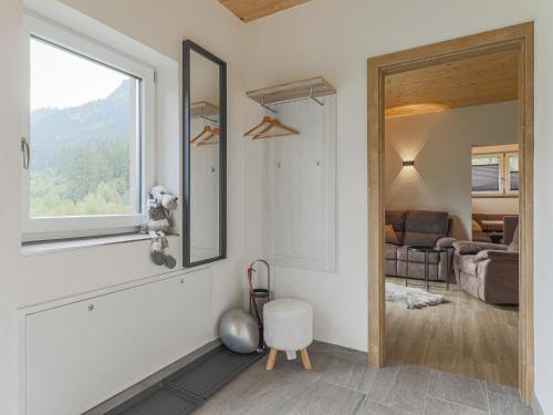 a living room with a window and a room with a couch at Michaela in Bramberg am Wildkogel